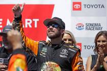 Martin Truex Jr. celebrates after winning a NASCAR Sprint Cup Series auto race Sunday, June 23, ...