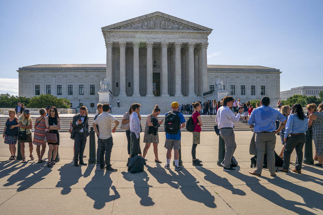 Visitors line up to enter the Supreme Court on Capitol Hill in Washington, Monday, June 24, 201 ...