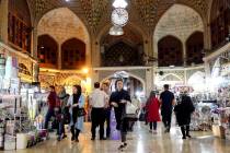 People shop at the old main bazaar in Tehran, Iran, Sunday, June 23, 2019. The most-visible pla ...