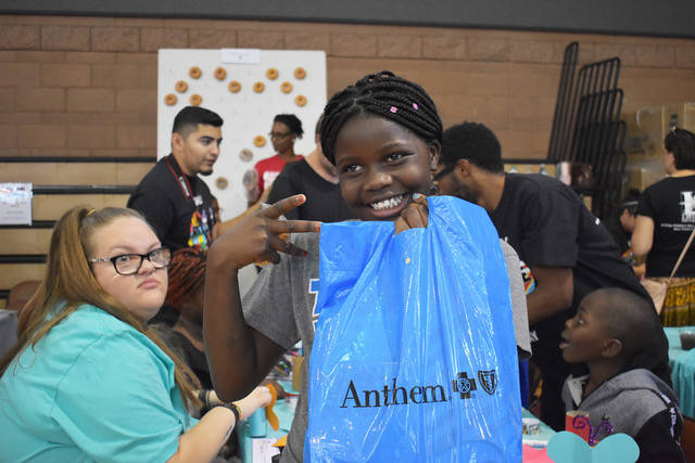 Kashindi Christina, 11, asked for her photo to be taken at the World Refugee event on Thursday, ...