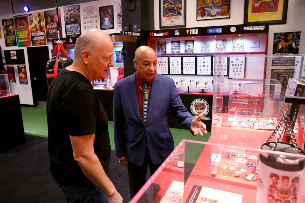 International Boxing Hall of Fame referee Joe Cortez, right, gives HeadzUP co-owner Tim Shelb ...