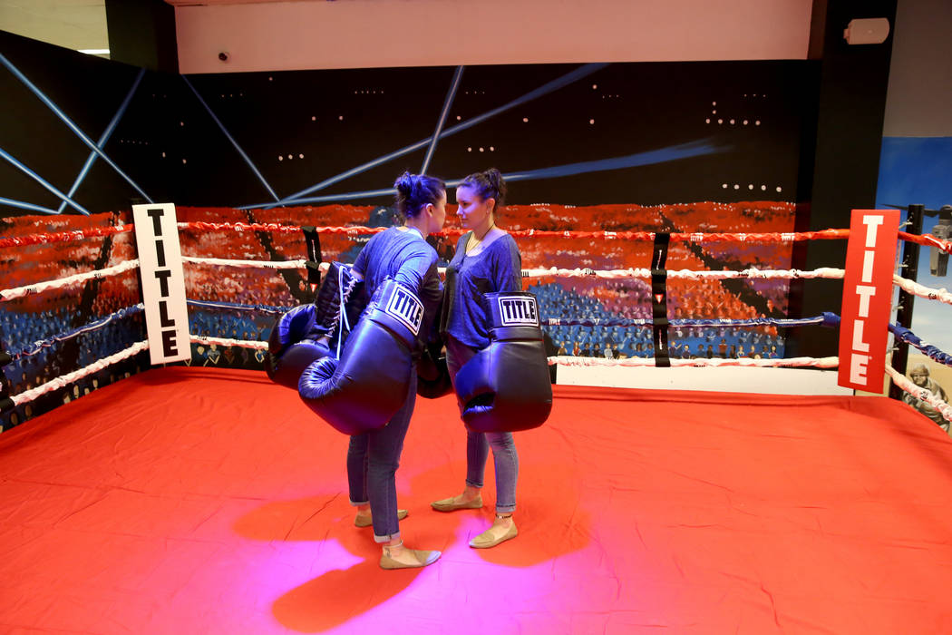 Jamie Vincek, left, and her twin sister Brandie Vincek face off with oversized gloves in the bo ...