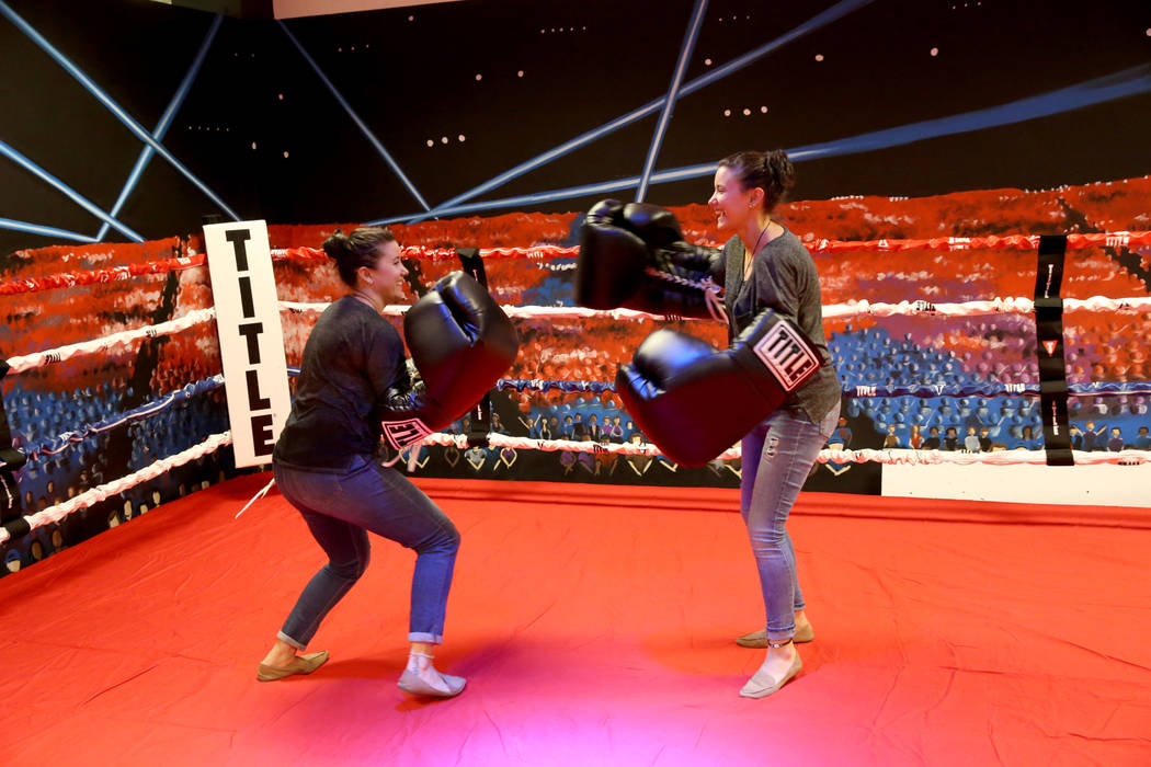 Jamie Vincek, left, and her twin sister Brandie Vincek face off with oversized gloves in the bo ...