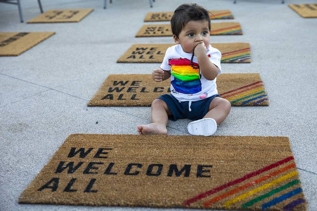 Adan Darun, 11 months old, relaxes among welcome mats near the main concourse during Pride Nigh ...