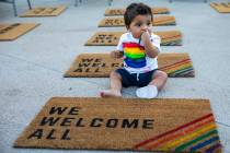 Adan Darun, 11 months old, relaxes among welcome mats near the main concourse during Pride Nigh ...