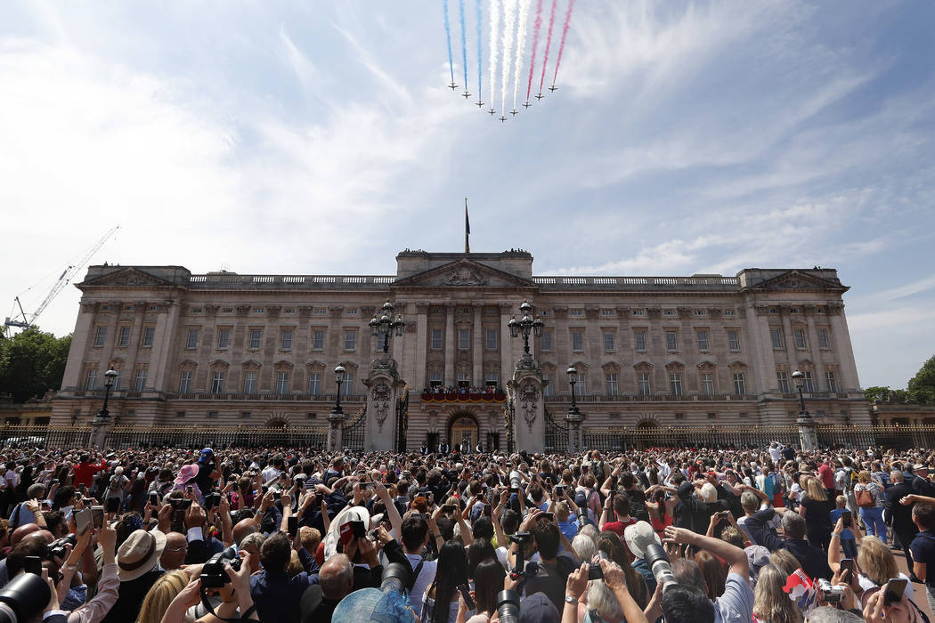 In this Saturday, June 9, 2018 file photo, Red Arrows fly over Buckingham Palace to attend the ...