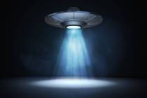 A 3D rendered illustration of a light beam from a flying UFO. (Getty Images)