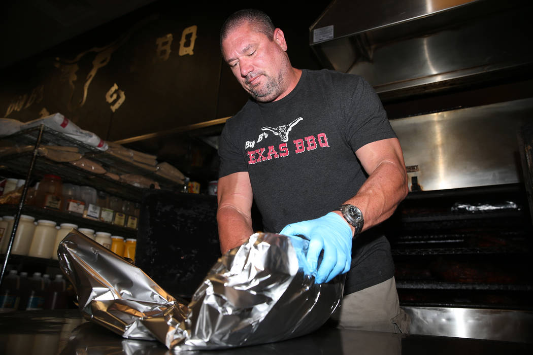 Brian Buechner, owner of Big B's Texas BBQ in Henderson, wraps a brisket at his restaurant, Sat ...