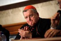 Cardinal Raymond Burke applauds during a press conference on the first anniversary of the death ...