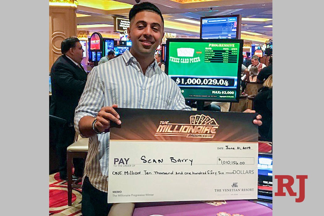 Sean Barry of Ohio shows off his winnings after connecting on the Millionaire Progressive on Fr ...