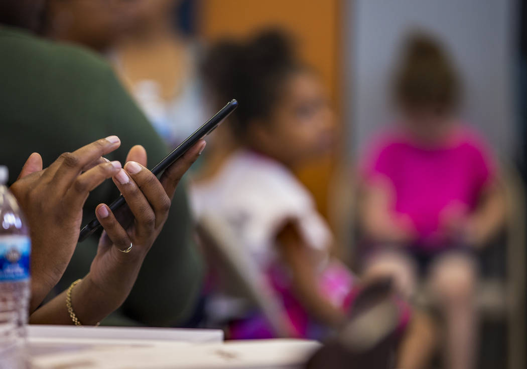 Invited guests at the Marble Manor Community Center learn how to operate a free Galaxy tablet w ...
