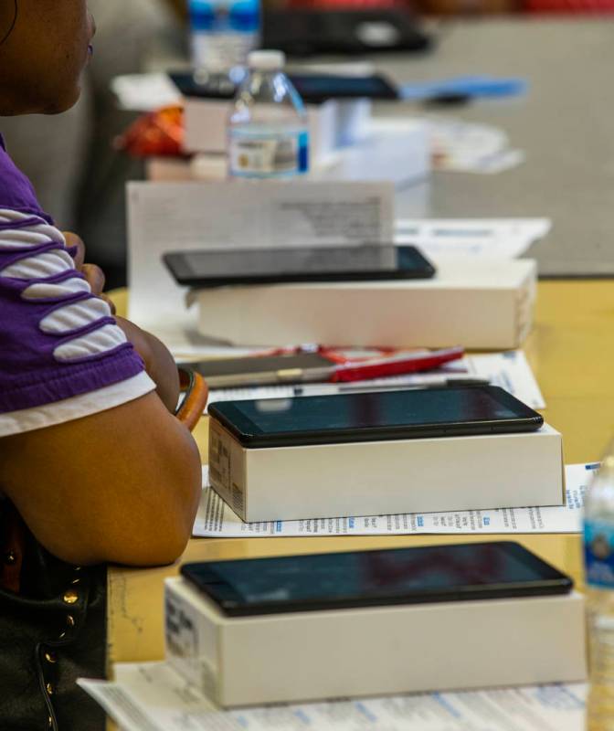Invited guests at the Marble Manor Community Center learn how to operate a free Galaxy tablet w ...