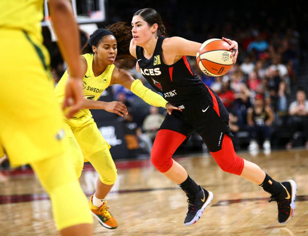 Las Vegas Aces guard Kelsey Plum, right, drives against Seattle Storm guard Jordin Canada durin ...