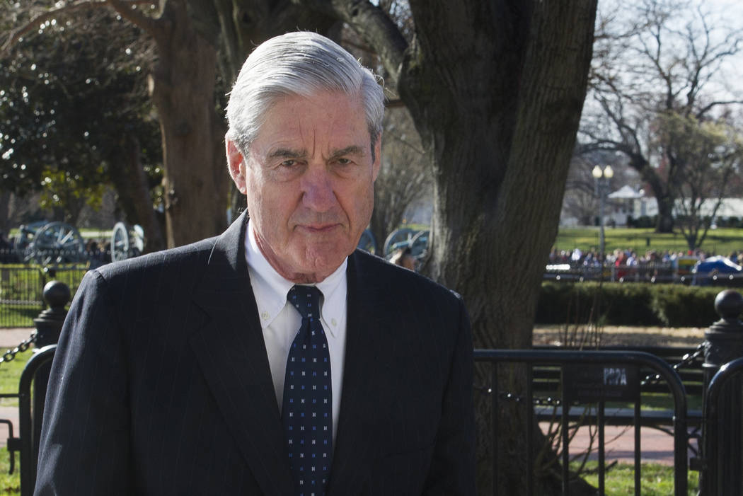 FILE - In this March 24, 2019 photo, then-special counsel Robert Mueller walks past the White H ...