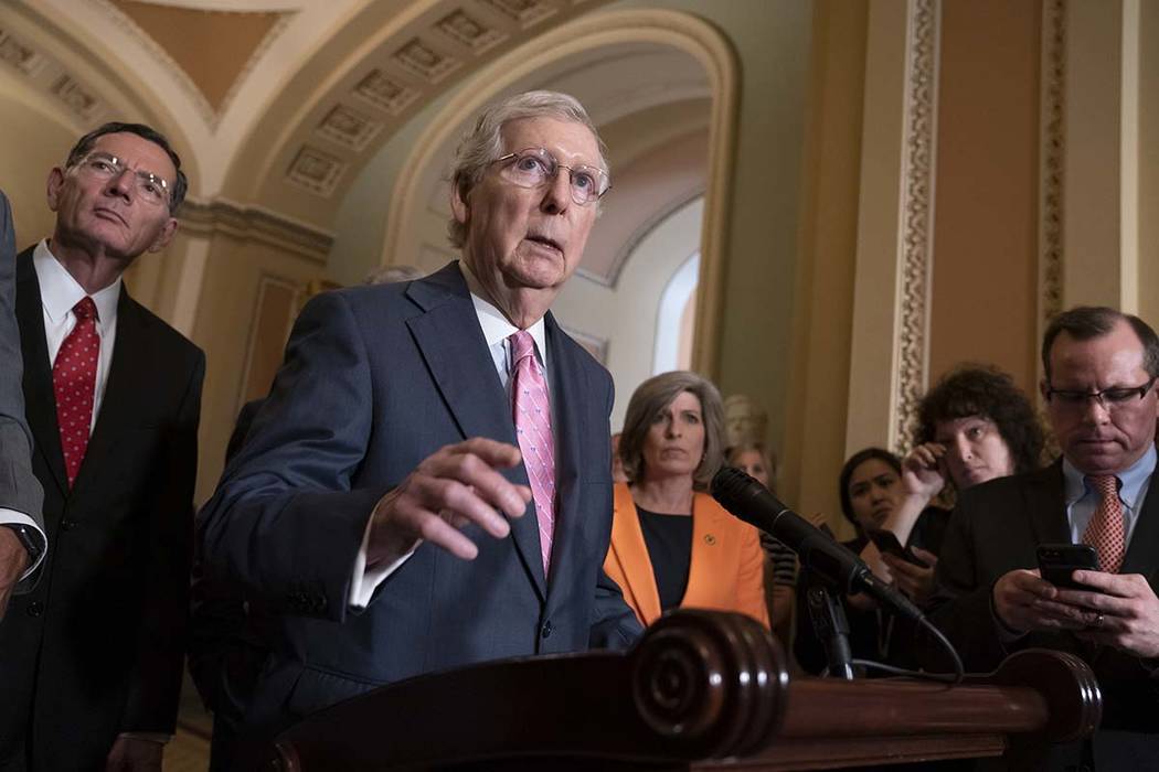Senate Majority Leader Mitch McConnell, R-Ky., joined at left by Sen. John Barrasso, R-Wyo., an ...