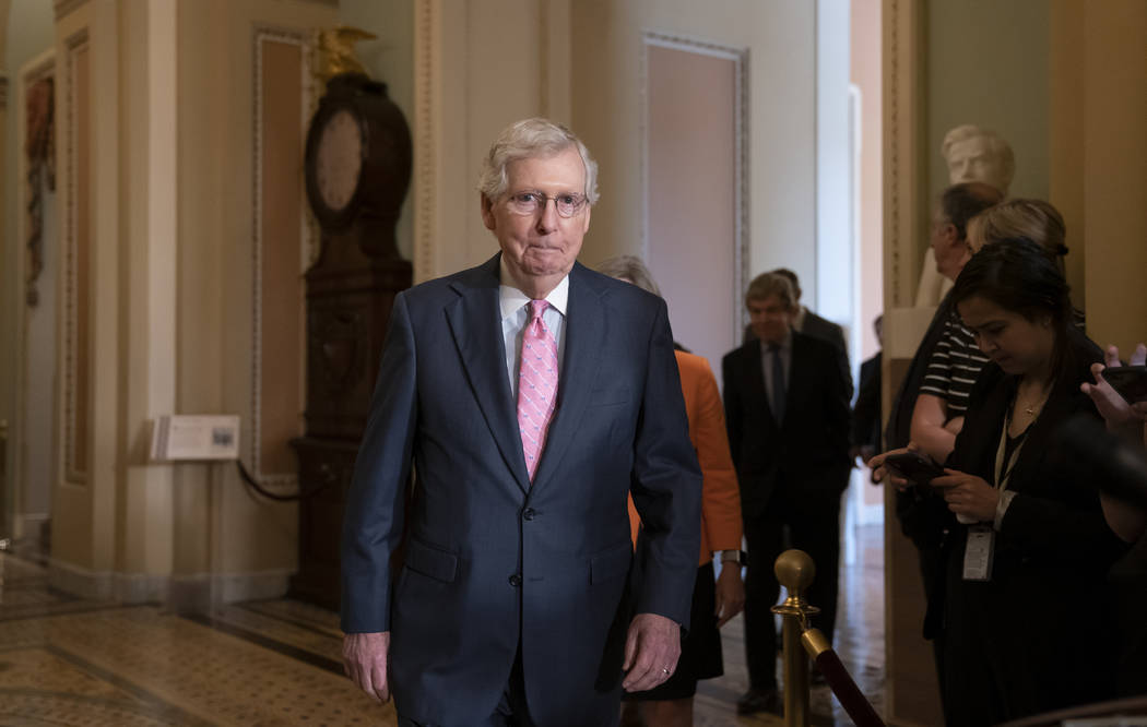 Senate Majority Leader Mitch McConnell, R-Ky., arrives to speak to reporters following the Repu ...