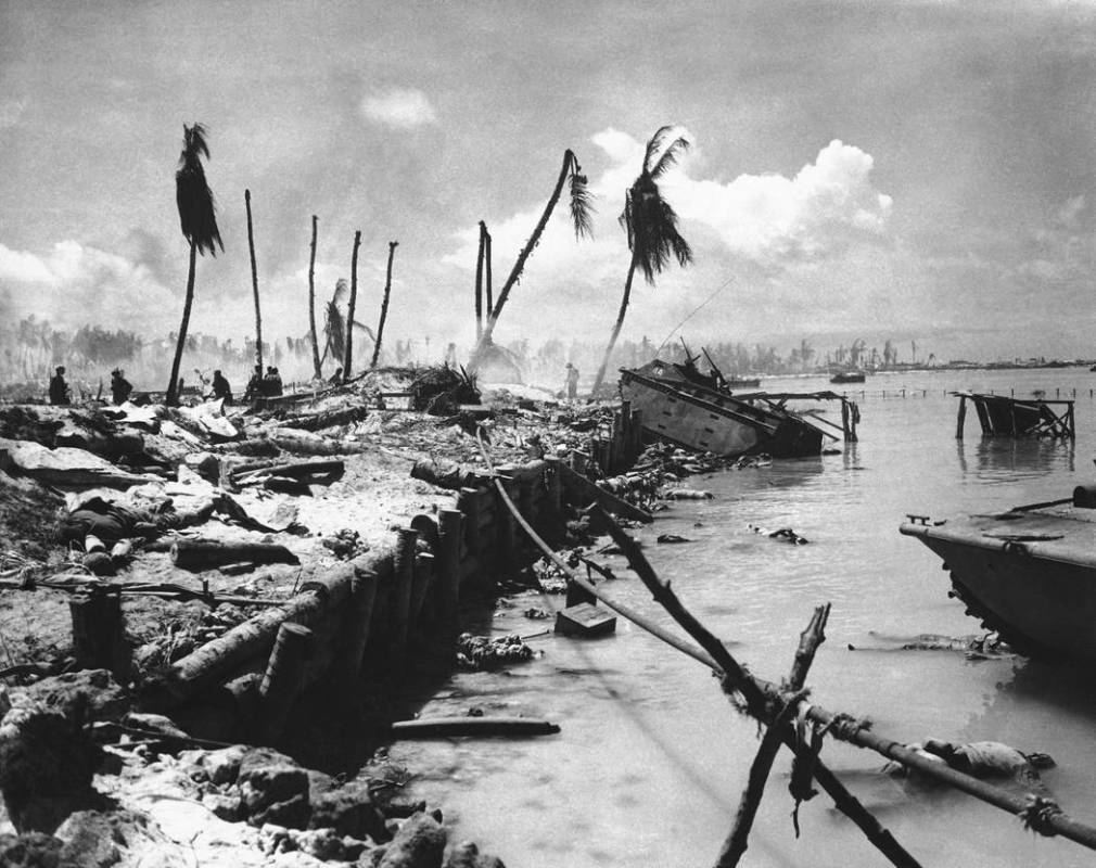 FILE - In this November 1943 file photo, bodies and wrecked amphibious tractors litter a battle ...