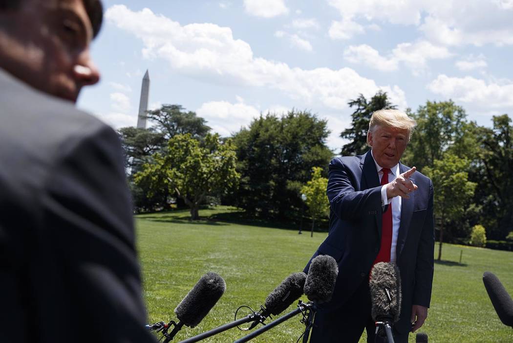 President Donald Trump talks with reporters before departing to Japan for the G20 summit, Wedne ...