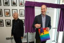 Britain's Prince William, the Duke of Cambridge, reacts to receiving a gift bag from trust chie ...