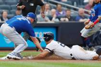 Toronto Blue Jays starting pitcher Clayton Richard, left, tags out New York Yankees' Giancarlo ...