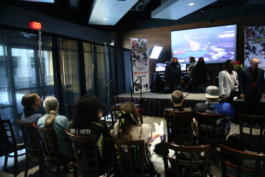 Players compete in the Super Smash Bros. Ultimate Showdown tournament at GameWorks in Las Vegas ...