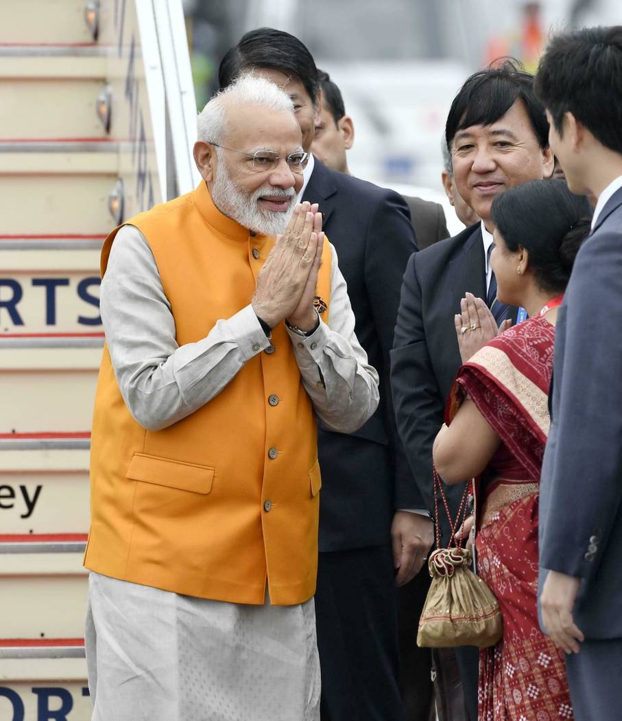 Indian Prime Minister Narendra Modi is greeted on his arrival at Kansai International Airport i ...