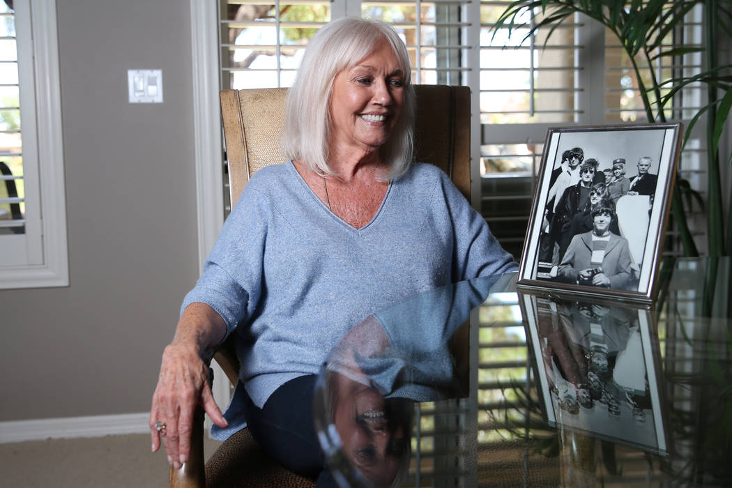 Sonnie Sims, a retired flight attendant, with a picture of herself with the Beatles in 1966, at ...