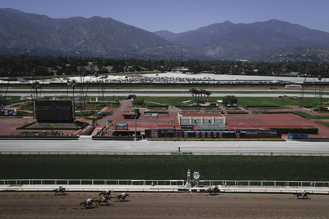 Horses finish the fourth race during the last day of the winter/spring meet at the Santa Anita ...