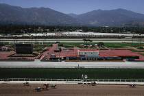 Horses finish the fourth race during the last day of the winter/spring meet at the Santa Anita ...
