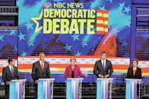 Democratic presidential candidate Sen. Elizabeth Warren, D-Mass., center, answers a question, d ...