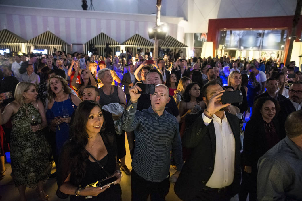 Attendees react to a fireworks show highlighting an event to announce the renaming of SLS Las V ...