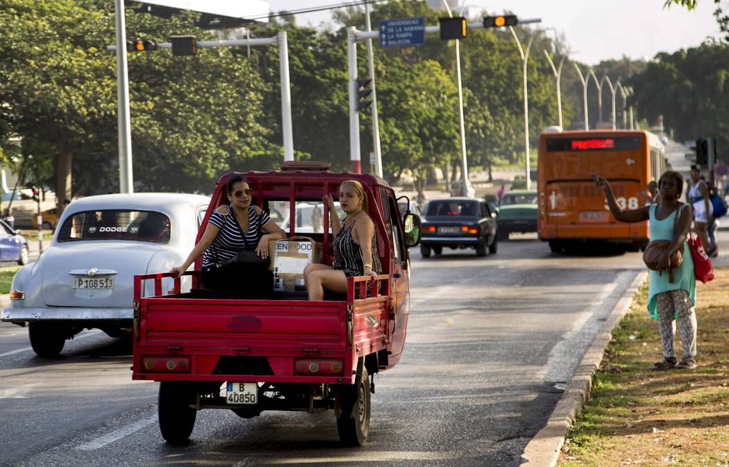 Women ride in the back of a vehicle in Havana, Cuba, Thursday, June 27, 2019. Cuban President M ...
