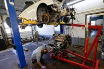 Automotive technicians Don Dimond, left, and Bernie Rabinovitz prepare to separate an engine an ...