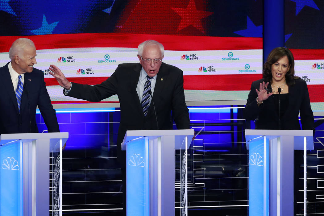 Democratic presidential candidate Sen. Bernie Sanders, I-Vt., , center, gestures towards former ...