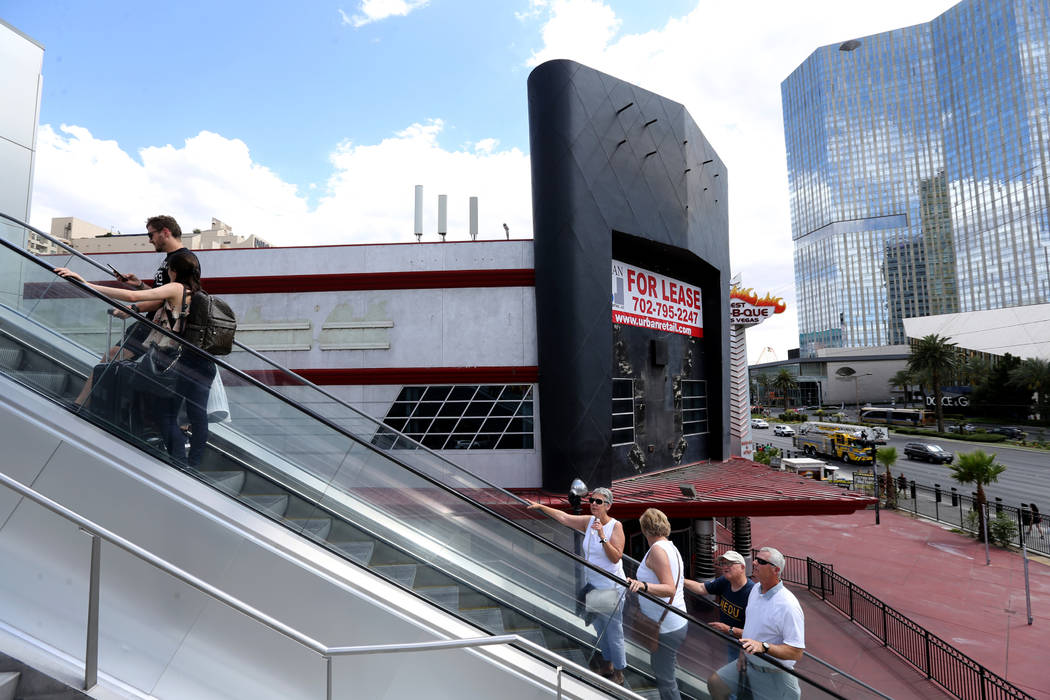 People take an escalator on the Strip near Harmon Avenue past a 16-acre piece of property that ...