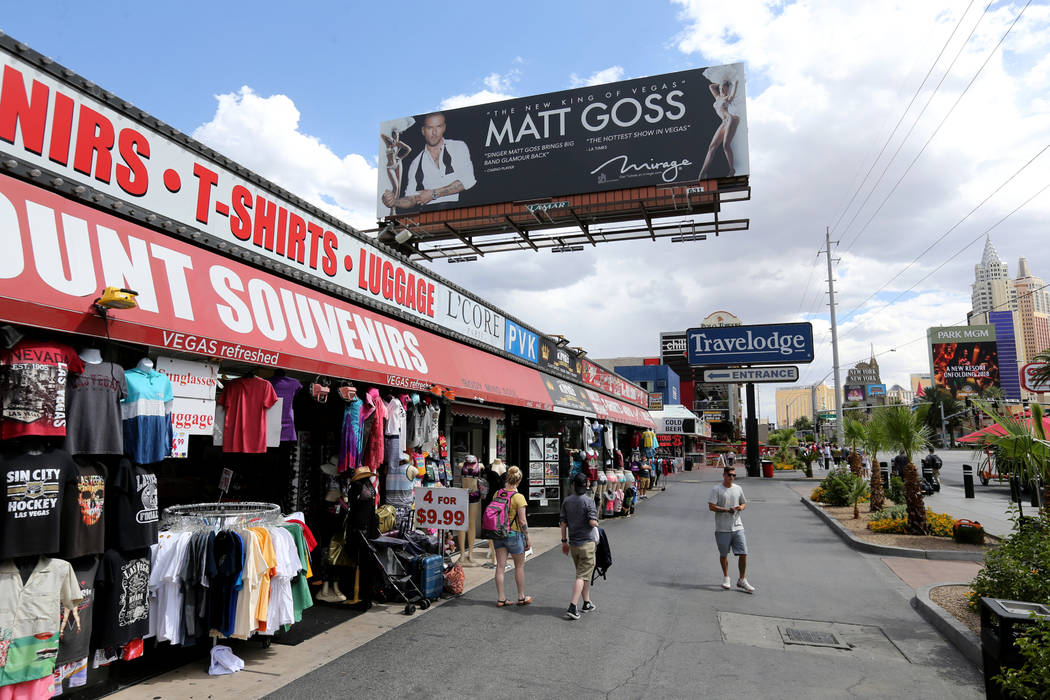 People walk on the Strip near Harmon Avenue past a 16-acre piece of property that includes the ...