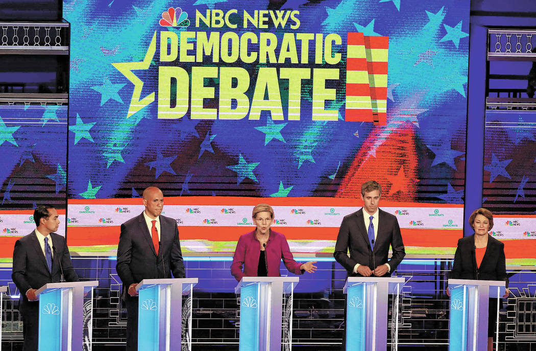 Democratic presidential candidate Sen. Elizabeth Warren, D-Mass., center, answers a question, d ...