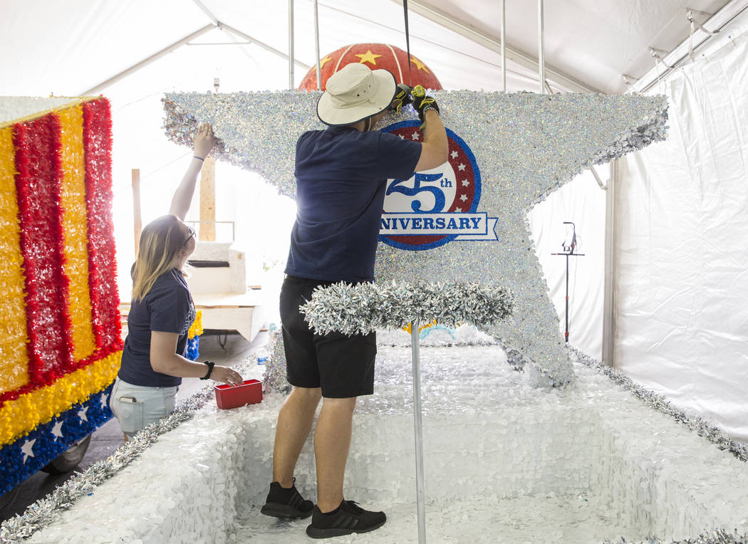 Julien Mihy, right, and Jordyn Doyle work on a float during preparation for the Summerlin Patri ...