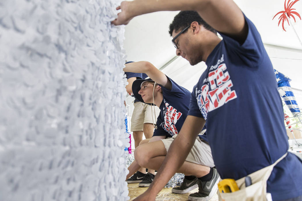 Connor Jordan, center, and Dwight Jones work on a float during preparation for the Summerlin Pa ...