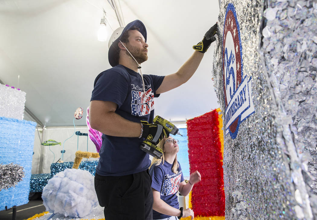 Julien Mihy works on a float during preparation for the Summerlin Patriotic Parade on Saturday, ...