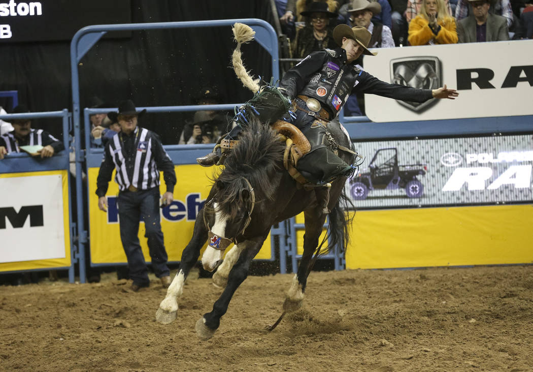 Zeke Thurston of Alberta, Canada (42) competes in the saddle bronc riding event during the nint ...