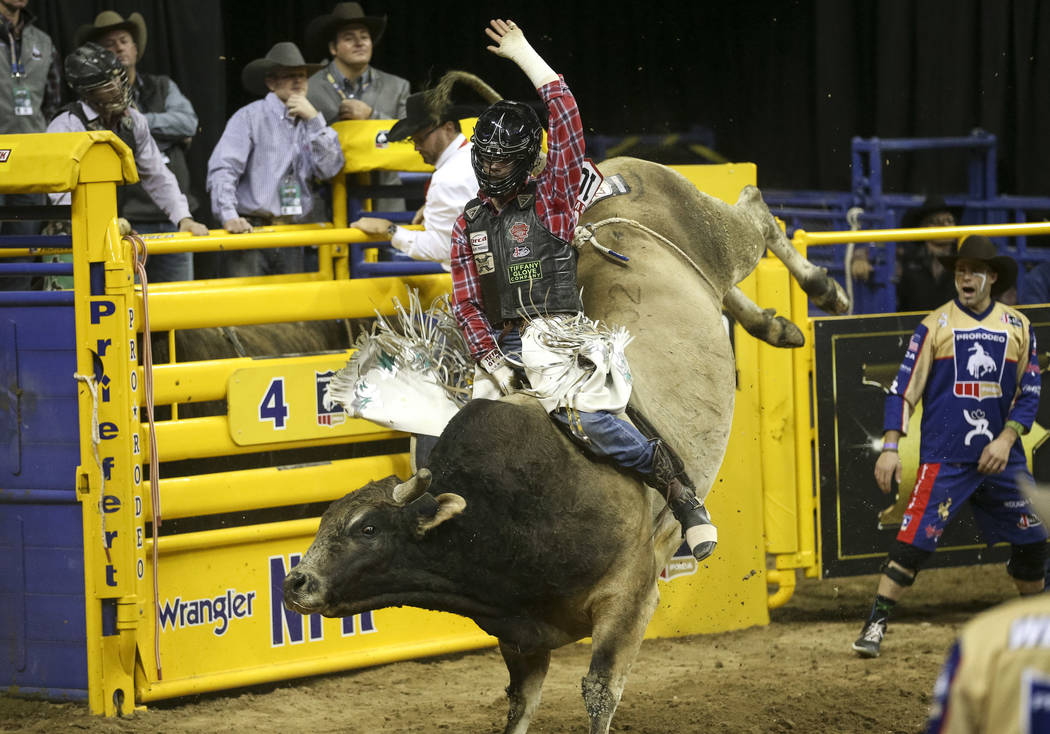 Eli Vastbinder of Union Grove, N.C. (105) competes in the bull riding event during the ninth go ...