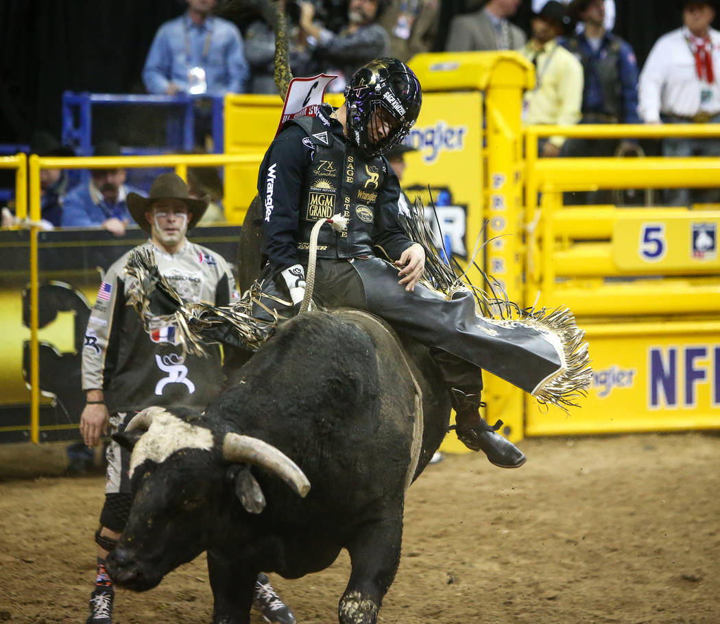 Sage Kimzey of Strong City, Okla. (3) rides "Joker" while competing Bull Riding durin ...