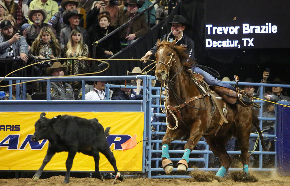 Trevor Brazile of Decatur, Texas (2) competes in tie-down roping during the tenth go-round of t ...