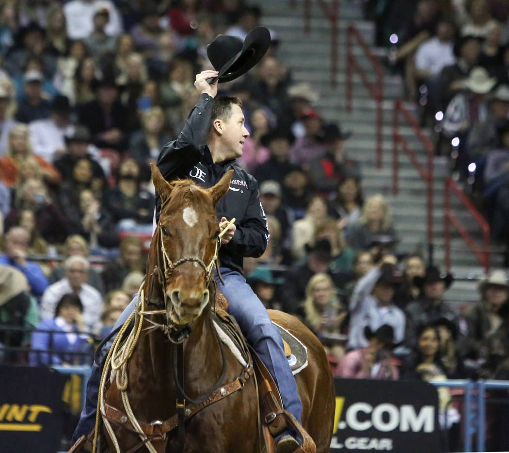 Trevor Brazile of Decatur, Texas (2) tips his hat after competing in tie-down roping during the ...