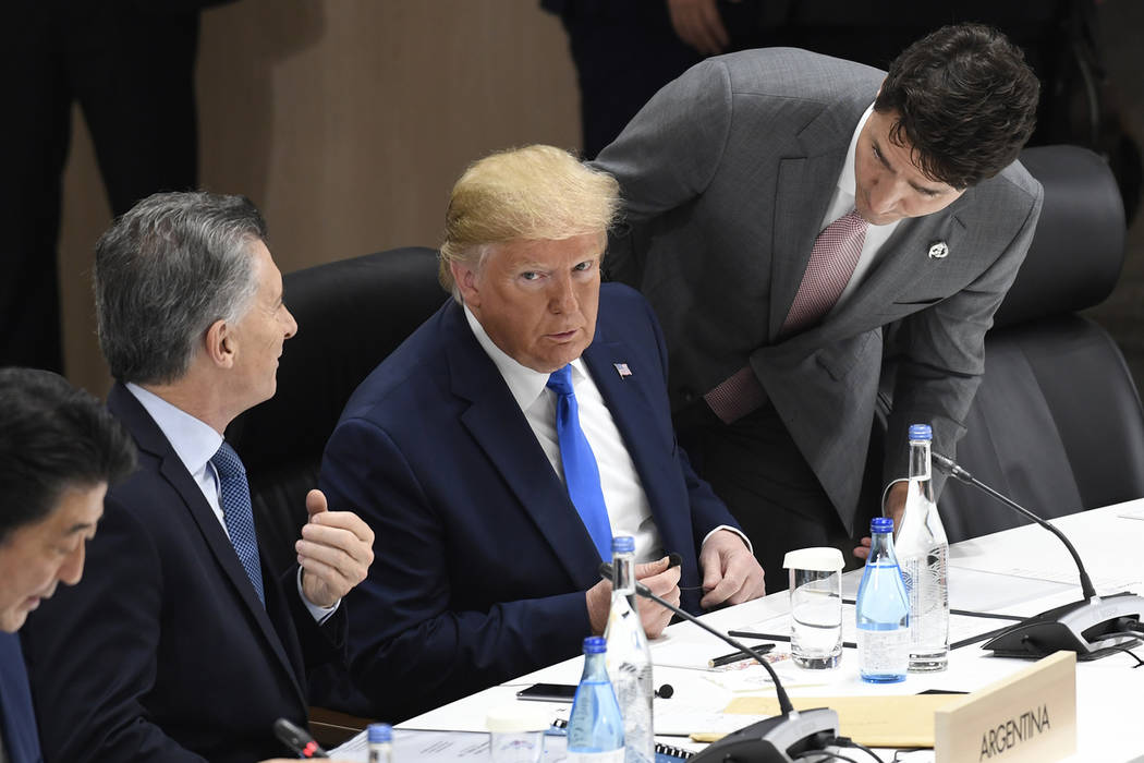 President Donald Trump, center, talks with Argentine President Mauricio Macri, left, and Canadi ...