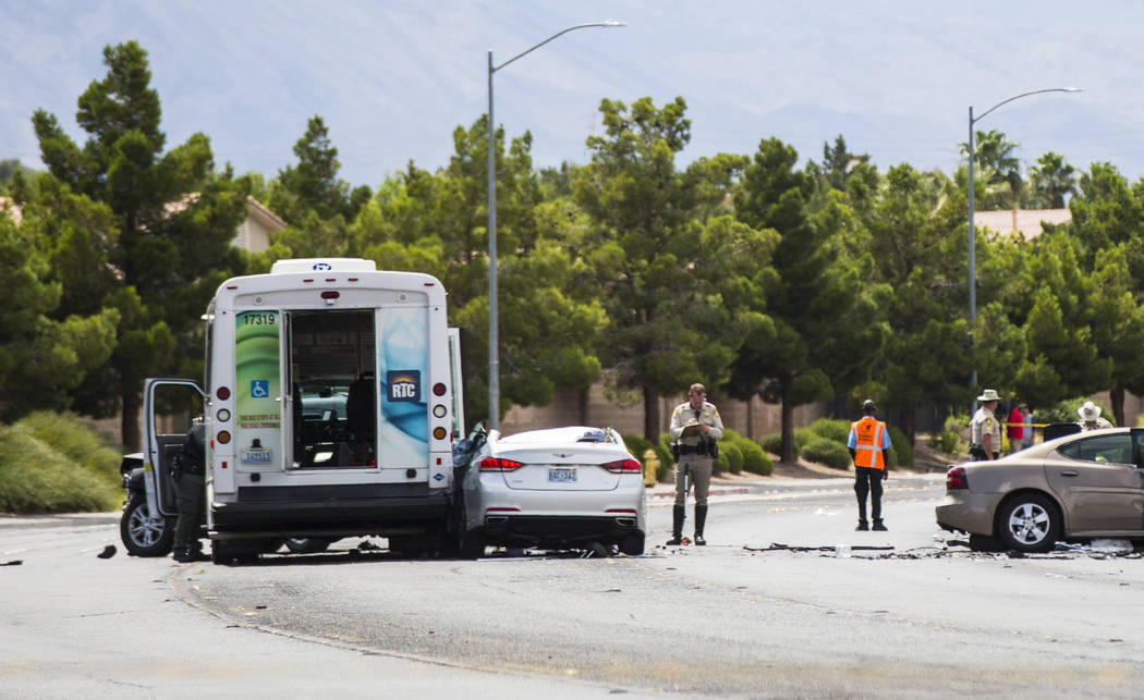 Las Vegas police investigate the scene of an accident involving three cars and a bus on Lake Me ...