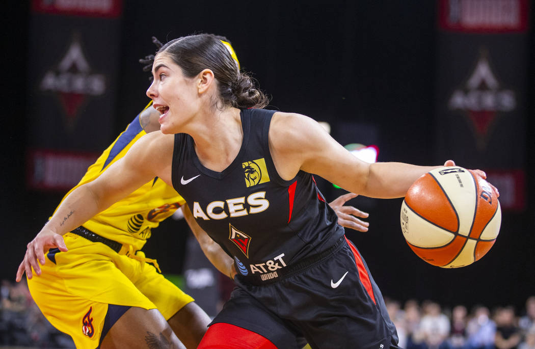 Las Vegas Aces guard Kelsey Plum drives past an Indiana Fever defender to the basket during the ...