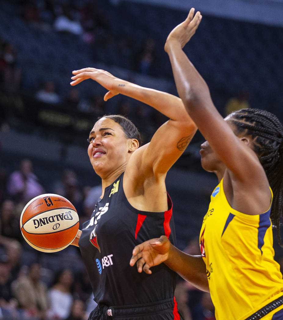 Las Vegas Aces center Liz Cambage, left, battles to the basket with Indiana Fever center Teaira ...