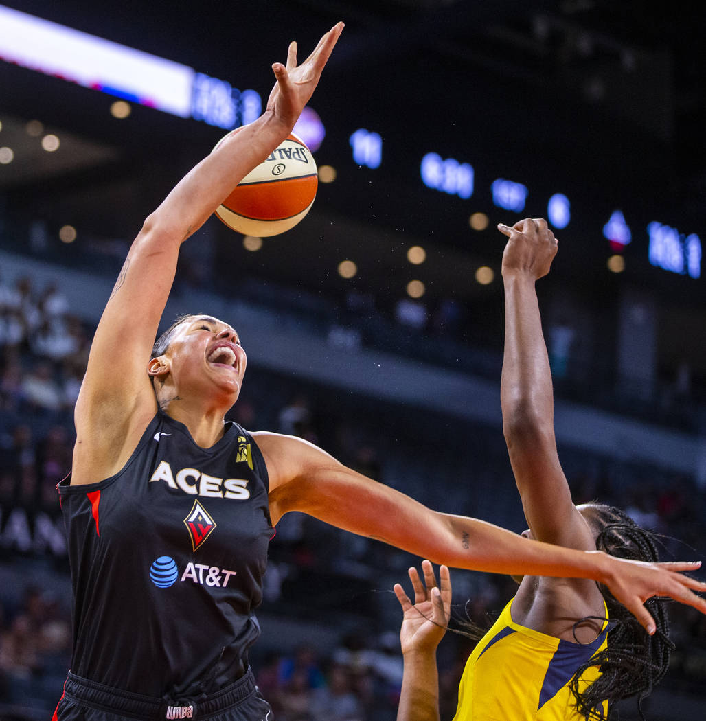 Las Vegas Aces center Liz Cambage, left, is fouled while driving to the basket by Indiana Fever ...